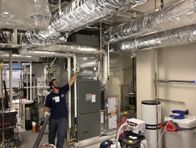 Littleton Air Duct Cleaning specialist performing thorough furnace duct cleaning in a Littleton residence