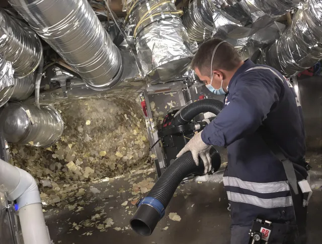 Littleton Air Duct Cleaning specialist operating negative pressure cleaning equipment for thorough duct maintenance in Littleton