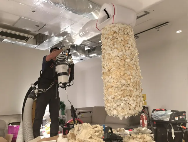 Littleton Air Duct Cleaning technician performing precision vacuum insulation removal in a residential property in Littleton